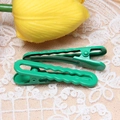 Detail of two green macaron hair clips on lace fabric with a decorative yellow tulip - 1.2x4.9cm / Christmas Green-Wave