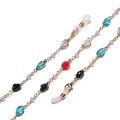 Gold glasses chain with colorful crystal beads and white pearls on white background - Colorful
