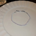 Elegant silver tennis bracelet with sparkling round zircons laid on a ceramic plate - Small Square Style (37#)