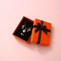 Orange jewelry gift box with gold necklace earrings and ring set featuring black ribbon - 7x9x3cm / Orange