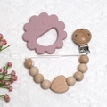 Pink lion silicone teether with wooden heart pacifier clip on white knit background - Lion Teether + Beaded Chain / Milk Tea