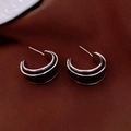 Detailed view of C-shaped silver earrings with dark enamel inlay on textured fabric - Silver-Black (C-Shape Two-Tone)