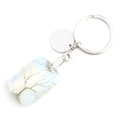 Macro detail of silver wire tree of life wrapped on rectangular moonstone keychain - Synthetic Opal