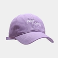 Close-up of the Keep Going white embroidery on a light purple cotton baseball cap - Light Purple