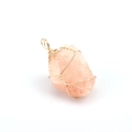 Detail of pink crystal stone pendant with handcrafted gold wire wrap on white background - Rose Quartz