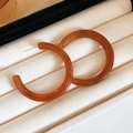 Detail of C-shaped amber resin hoop earrings resting on a soft velvet jewelry tray - Coffee Square Resin C-Shape (925 Sterling Silver Earring Post)