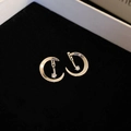 Detail of silver crescent moon stud earrings with single zircon on black velvet - Silver