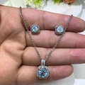 Detailed close-up of light blue zircon square pendant and earring set in silver - Ice Blue
