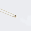 Minimalist gold necklace featuring a black square cube pendant with a golden letter J - Letter J