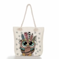 Detail of canvas tote bag featuring a colorful cartoon owl print and soft rope handles - Feather Headdress Tribal Owl