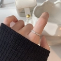 Minimalist 925 sterling silver twist ring with zircon inlays worn on index finger - Twisted Rope with Pavé Zircon