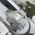 Macro view of silver square watch face with double-row crystal bezel and Jadi logo - Silver