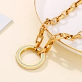 Detail view of a thick gold chain necklace with a round sparkling cubic zirconia pendant - Gold Necklace (KN226258-Z)