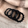Five black fuzzy elastic hair ties with oval bead accents on a plaid background - Pure Black [4Pcs]