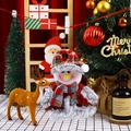 Close-up of a plush Christmas snowman ornament with red plaid details and festive decor - Snowman