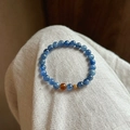 Blue kyanite beaded bracelet with tiger eye accent and gold charm on grey fabric - Gold-Blue-Natural Stone (Exquisite Gift Box)