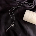Minimalist silver bar necklace with engraved round disc on elegant black silk background - Silver Round Style