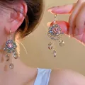 Detailed view of pink floral crystal tassel earrings worn on ear with drop pendants - 23# Ear Hook - Gold - Blue