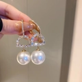 Macro shot of gold D-shape earrings with sparkling crystals and large white pearls - 27# Gold White Pearl