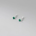 Macro shot of a four-prong minimalist earring with a brilliant round-cut green gemstone - 999 Fine Silver Pair - 2mm Green Zirconia