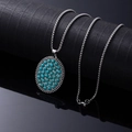 Vintage bohemian necklace featuring a silver oval pendant with turquoise inlay detail - Dot Tag