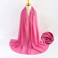 Pink pearl chiffon hijab scarf for women elegantly draped on a golden display stand - Pink