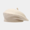 Detailed texture view of a thick warm knitted beige beret hat for women with soft wool fabric - M / Beige