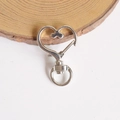 Close-up of a heart-shaped silver metal spring lobster clasp for keychains and bags - White K/Silver