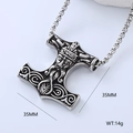 Macro detail of Mjolnir Thor hammer pendant featuring Viking carvings and metal etchings - Thor's Face Mjolnir (Style 9)