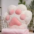 Cute white cat paw plush cushion with pink pads on a matching soft pink blanket - White