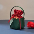 Detail of green leather gift bag with red velvet pouch and Christmas gold tag - Green Bucket + Red Velvet Bag