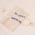 Detail of bohemian clay bead necklace with pearls and gold heart pendant on stone - Mixed Blue #7