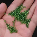 Emerald green glass seed beads for DIY jewelry making held in hand for size reference - 3mm / 15g / Green