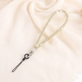 Close-up of luxury gold and silver rhinestone chain strap for mobile phone accessories - Yellow