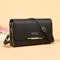 Elegant black pebbled leather crossbody long wallet with gold zippers on beige background - Black