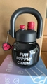Close-up of black kettle-shaped insulated bottle with pink charms and dual-drink lid - 650ML Black Insulation Cup + Doll