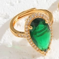 Adjustable golden ring featuring a pear-cut green emerald stone and zircon halo - Emerald Teardrop
