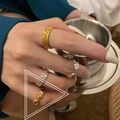 Set of gold and silver knot-style rings and clear beaded ring shown on hand - Knotted Weave Combo Style (TJZ281) / Gold