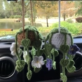 Handmade crochet hanging plant car charms with brown and white pots on a rearview mirror - Brown Basket + White Five-Petal Flower
