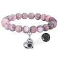 Pink zebra stone beaded bracelet with heart projection charm showing I Love You in 100 languages - Pink Zebra Stone
