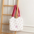 Quilted canvas tote with cherry print and soft pink fleece handle on wooden ladder - White