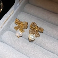 Golden bow stud earrings with white irregular pearl pendant on velvet background - Gold Hollow Bowknot Irregular Pearl Stud Earrings (65# Silver Needle - Gold (Real Plated))
