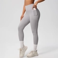 Detail view of high-waisted yoga leggings with side pockets and compression fabric - S / Bottoms / Frost Grey