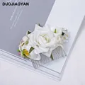 Elegant bohemian bridal hair comb featuring white silk roses and green leaf accents - FS09-1 White