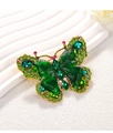 Detailed macro view of forest green crystal butterfly brooch with champagne gold plating - Forest Green Butterfly