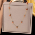 Macro view of gold stainless steel chain with reddish-brown gemstone beads - Irregular Red Stone Necklace (H634) / Gold