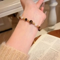Tiger eye stone and white pearl beaded bracelet with golden hollow charms on wrist - Tiger Eye Pearl Gold Hollow (MY36709)