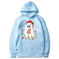 Light blue Christmas hoodie with festive ghost prints and kangaroo pocket on white background - Light Blue