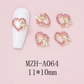 Macro-opname van 11x10mm roze strass hart nagelbedeltjes met gouden holle strik details - Gouden Hol Hart Met Strikstijl (A064)