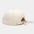 Detailed close-up of beige canvas docker hat with white Brooklyn letter embroidery - Beige